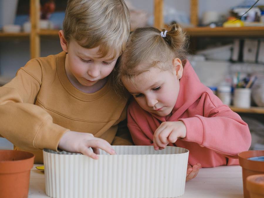 Two children making crafts at a table