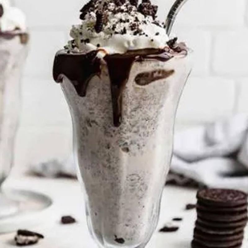 Oreo milkshake topped with cream and cookie pieces